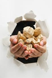 2 hands breaking through with gold nuggets