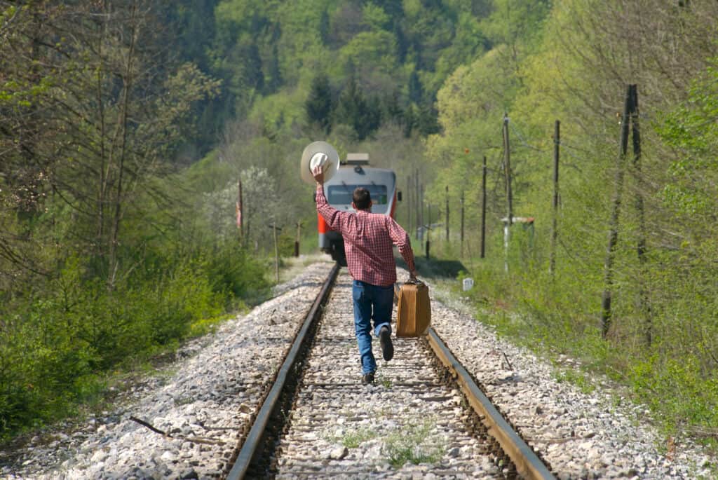 Man in western style is running to catch the train.